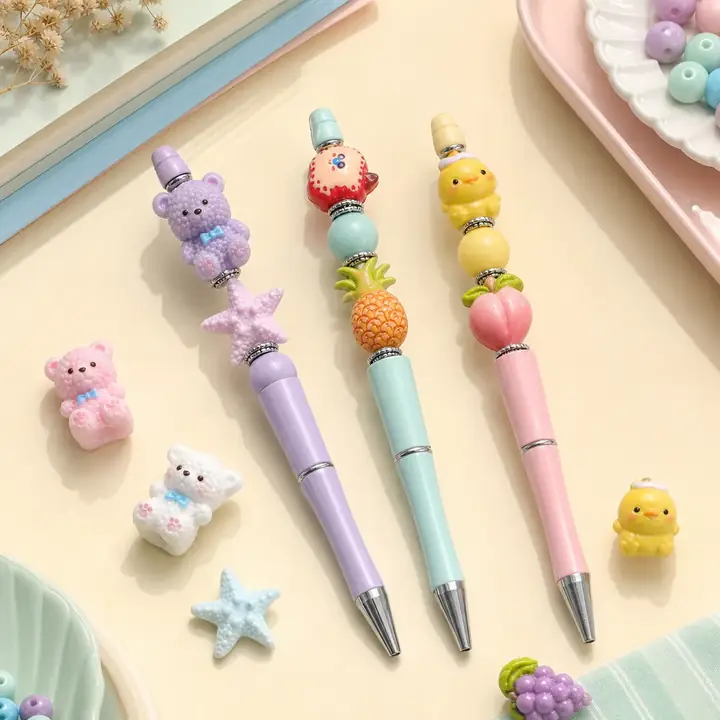 Finished beadable pens with bear, starfish, fruit, and duck focal beads